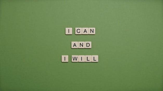 Inspirational message 'I Can and I Will' spelled with tile letters on a green background.
